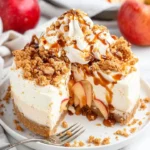 Delicious slice of Apple Crumble Cheesecake topped with crumbled apples and spices.