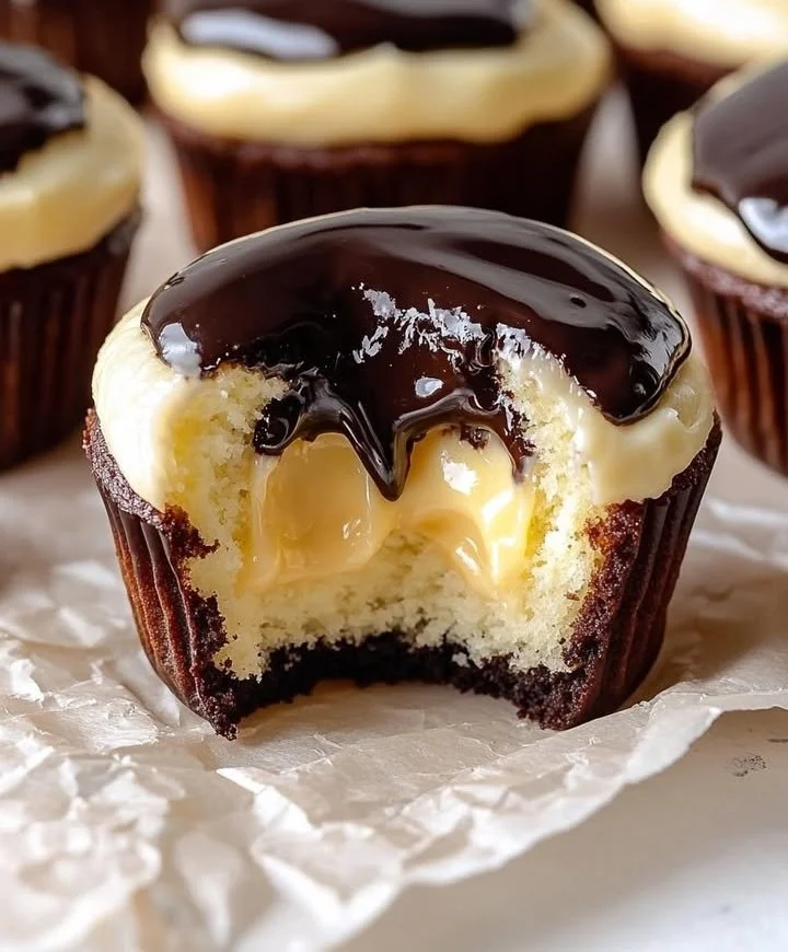 Delicious Boston Cream Cupcakes topped with chocolate and filled with vanilla custard
