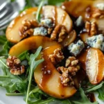 Caramelized pear and blue cheese salad topped with nuts and greens