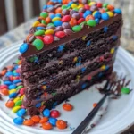 Delicious Chocolate M&M Celebration Cake topped with colorful candies