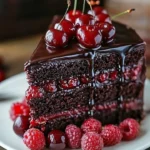 Decadent Chocolate Raspberry Truffle Cake decorated with fresh raspberries and chocolate shavings