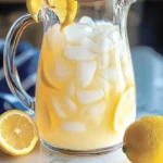 A refreshing creamy lemonade in a glass with a lemon garnish