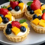 Creamy mini fruit tarts topped with fresh fruit and creamy filling
