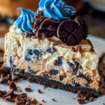Slice of Delicious Cookie Monster Cheesecake topped with cookies and blue frosting