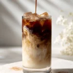 Delicious Dirty Horchata Latte topped with an espresso swirl in a coffee cup.