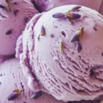 Delicious bowl of honey lavender ice cream topped with lavender flowers