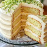 Delicious key lime cake topped with creamy frosting and garnished with lime slices