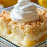 Lemon cream cheese dump cake served on a plate with fresh lemon slices