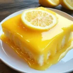 Slice of Lemon Sunshine Glaze Cake with a vibrant lemon glaze on top
