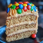 M&M's Peanut Butter Cake with creamy peanut butter frosting on a plate