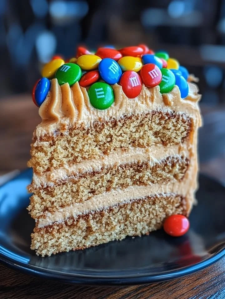 M&M's Peanut Butter Cake with creamy peanut butter frosting on a plate