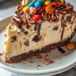 No-Bake M&M Snickers Cheesecake with colorful candies and chocolate toppings