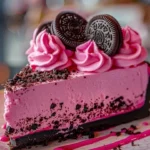 Pink Velvet Oreo Cheesecake topped with cream and crushed Oreos