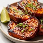 Roasted sweet potato steaks with gochujang-maple glaze on a plate