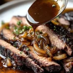 Slow Cooker Brisket served with rich Balsamic Onion Gravy on a plate