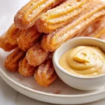 Sweet potato churros with salted caramel goat cheese dip on a plate