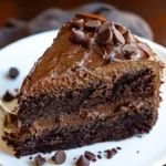 Decadent triple chocolate cake topped with rich chocolate frosting and shavings.