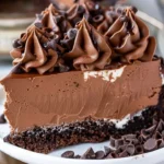 Decadent Triple Chocolate Cheesecake topped with rich chocolate ganache and shavings