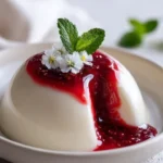 Plate of White Burrata Panna Cotta with a vibrant liquid raspberry core