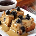 Wild Berry Bread Pudding topped with Orange Sauce dessert dish